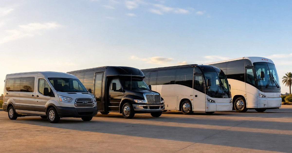 A lineup of charter vehicles from a passenger van to a full-size motorcoach parked on a paved lot in warm evening light.